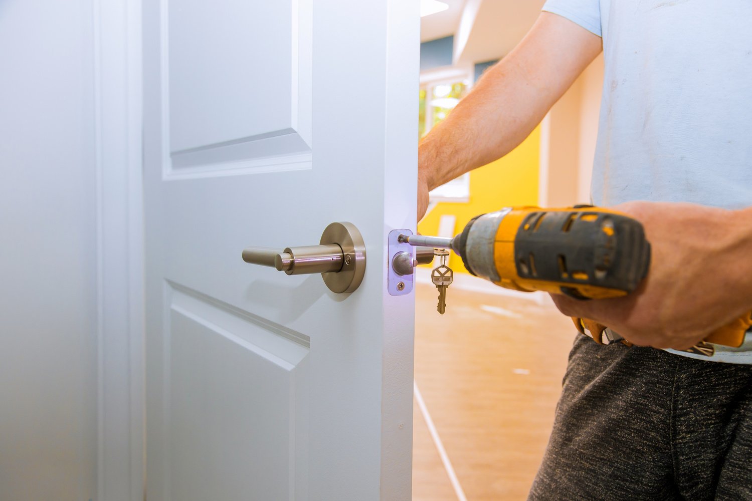 Carpenter Installing a Door Lock